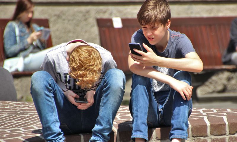 kinderen telefoon buiten spelen onderzoek ouders scherm